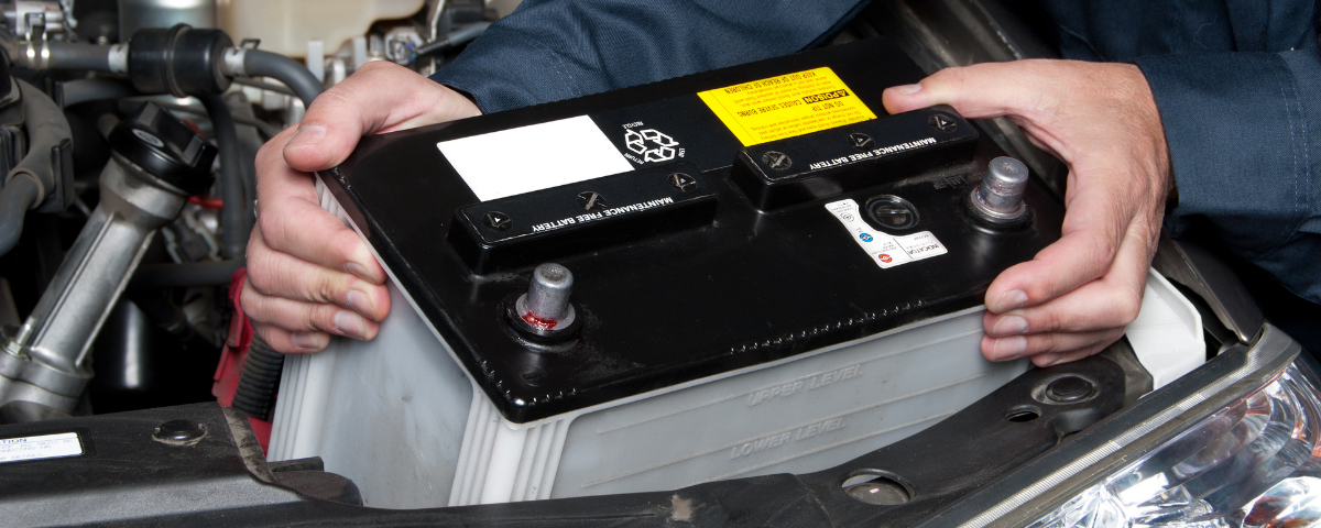 Man taking battery out of car